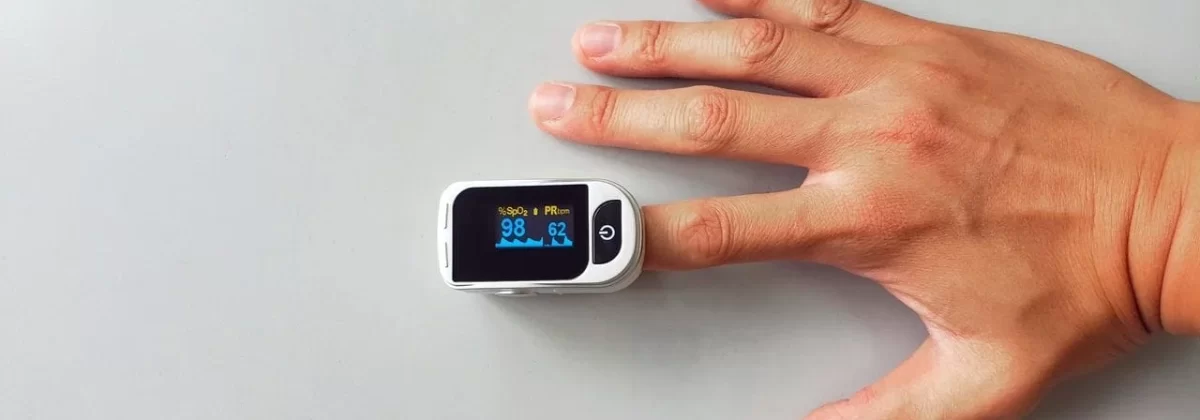 hand-with-finger-in-pulse-rate-monitor