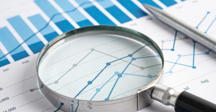 magnifying-glass-laying-on-sheets-of-data